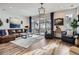 Bright living room with hardwood floors, a modern fireplace, and ample seating at 1784 Cade Ave, Castle Rock, CO 80104