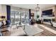 Sun-drenched living room with a fireplace, hardwood floors and patio access at 1784 Cade Ave, Castle Rock, CO 80104