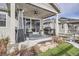 Cozy covered patio with a ceiling fan, heaters, BBQ, furniture, rug, and easy access to the house through sliding glass doors at 1784 Cade Ave, Castle Rock, CO 80104