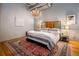 Spacious bedroom with hardwood floors, large bed, and chandelier at 1801 Wynkoop St # 205, Denver, CO 80202