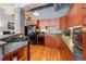 Modern kitchen with wood cabinets, breakfast bar and appliances at 1801 Wynkoop St # 205, Denver, CO 80202