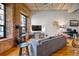 Living room with exposed brick wall, wood floors, and wood stove at 1801 Wynkoop St # 205, Denver, CO 80202