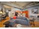 Open living room with exposed brick, wood floors, and kitchen at 1801 Wynkoop St # 205, Denver, CO 80202