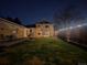 The backyard features a well-manicured lawn, patio, privacy fence with lighting and connection to the main house at 2488 S Zurich Ct, Denver, CO 80219