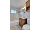 Bathroom featuring a tiled shower-tub, vanity, and window at 2488 S Zurich Ct, Denver, CO 80219