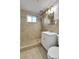 Bathroom featuring a tiled shower-tub, vanity, and mirror at 2488 S Zurich Ct, Denver, CO 80219