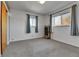 Bedroom with carpet, two windows with curtains, and a closet at 2488 S Zurich Ct, Denver, CO 80219