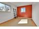 Cozy bedroom featuring wood floors, a colorful accent wall, and a minimalist ladder shelf at 2488 S Zurich Ct, Denver, CO 80219