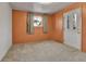 Bedroom featuring an orange wall, a window, and a closet at 2488 S Zurich Ct, Denver, CO 80219