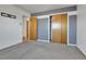 Spacious bedroom with gray accent wall and sliding closet doors at 2488 S Zurich Ct, Denver, CO 80219