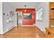 Elegant dining room boasts gleaming hardwood floors, custom lighting, a statement wall, and bright shuttered windows at 2488 S Zurich Ct, Denver, CO 80219