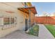 Back of home featuring basement access with awning, window with bars and landscaping at 2488 S Zurich Ct, Denver, CO 80219