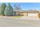 Ranch style home featuring a well manicured lawn, mature trees, and detached garage at 2488 S Zurich Ct, Denver, CO 80219
