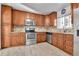 Well-appointed kitchen featuring stainless steel appliances, tile backsplash, granite countertops, and ample cabinet space at 2488 S Zurich Ct, Denver, CO 80219