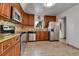 Modern kitchen featuring stainless steel appliances, custom cabinets, a tile backsplash, and granite countertops at 2488 S Zurich Ct, Denver, CO 80219