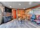 Entertainment space with brick, luxury vinyl flooring, and warm lighting at 2488 S Zurich Ct, Denver, CO 80219