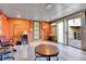 Finished basement area with brick accent wall, wood floors, and sliding door access to the backyard at 2488 S Zurich Ct, Denver, CO 80219