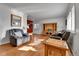 Inviting living room featuring hardwood floors, cozy recliners, and ample natural light from large windows at 2488 S Zurich Ct, Denver, CO 80219