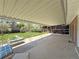 Covered back patio area with seating and a view of the backyard at 1822 Ura Ln, Northglenn, CO 80234