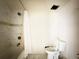 Clean bathroom with marbled tile shower, new toilet, and fixtures at 1822 Ura Ln, Northglenn, CO 80234