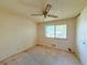 Bedroom featuring natural light from the large windows and ceiling fan at 1822 Ura Ln, Northglenn, CO 80234
