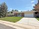 Charming single-Gathering home featuring a brick facade, well-manicured lawn, and an attached two-car garage at 1822 Ura Ln, Northglenn, CO 80234