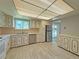 Well-lit kitchen with ample cabinet storage and stainless steel appliances and tile flooring with rear patio access at 1822 Ura Ln, Northglenn, CO 80234