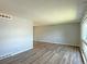 Spacious living room with hardwood floors, neutral paint, and large window with ample natural light at 1822 Ura Ln, Northglenn, CO 80234