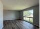 Bright living room showcasing sleek hardwood floors and a large window offering ample natural light at 1822 Ura Ln, Northglenn, CO 80234