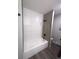 Modern bathroom features a tub with white textured subway tile and dark fixtures at 21 Douglas N Dr, Broomfield, CO 80020