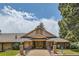 Inviting clubhouse entrance with a covered porch and professional landscaping at 21 Douglas N Dr, Broomfield, CO 80020