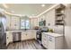 Contemporary kitchen boasts stainless steel appliances and gray subway tile backsplash at 21 Douglas N Dr, Broomfield, CO 80020