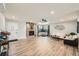 Cozy living room features a stone fireplace, light wood floors, and a window seat at 21 Douglas N Dr, Broomfield, CO 80020
