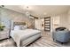 Stylish main bedroom features decorative accent wall and modern chandelier at 21 Douglas N Dr, Broomfield, CO 80020