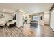 The open floorplan showcases the kitchen, living, and dining areas with wood floors and lots of light at 21 Douglas N Dr, Broomfield, CO 80020