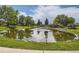 Community pond with fountain feature, lush surroundings, and a walking path at 21 Douglas N Dr, Broomfield, CO 80020