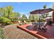 Backyard featuring a patio with dining and additional seating surrounded by lush greenery and blue skies at 8065 W Fremont Dr, Littleton, CO 80128
