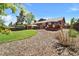Landscaped backyard featuring a deck and a shed with a lush lawn at 8065 W Fremont Dr, Littleton, CO 80128