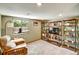 Finished basement with a comfortable chair and a shelving unit, perfect for a media or recreation room at 8065 W Fremont Dr, Littleton, CO 80128