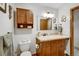Bathroom featuring wood cabinetry, modern fixtures, a neutral color palette and updated design elements at 8065 W Fremont Dr, Littleton, CO 80128