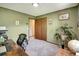 A carpeted bedroom with a double door closet, neutral decor and well-lit with natural light at 8065 W Fremont Dr, Littleton, CO 80128