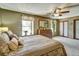 Serene primary bedroom featuring neutral tones, a large bed, and a light-filled window at 8065 W Fremont Dr, Littleton, CO 80128