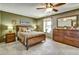Cozy bedroom with a comfortable bed, dresser, and ample natural light from the window at 8065 W Fremont Dr, Littleton, CO 80128