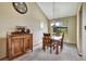 Charming dining area with wooden table set, accent cabinet, and bright window overlooking the yard at 8065 W Fremont Dr, Littleton, CO 80128