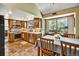 Updated kitchen with stainless appliances, natural wood cabinetry, and an adjacent dining area at 8065 W Fremont Dr, Littleton, CO 80128