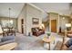 Inviting living room with vaulted ceilings, neutral carpet, and direct access to dining area at 8065 W Fremont Dr, Littleton, CO 80128
