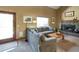 Inviting living room featuring a cozy fireplace, large sectional sofa, and abundant natural light at 8065 W Fremont Dr, Littleton, CO 80128