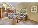 Spacious living room with vaulted ceilings, steps leading to the kitchen, and a large window at 8065 W Fremont Dr, Littleton, CO 80128