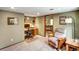 A well-lit home office space with a desk, chair, and view into the living area at 8065 W Fremont Dr, Littleton, CO 80128