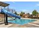 Community pool featuring a slide and sun loungers at 8065 W Fremont Dr, Littleton, CO 80128